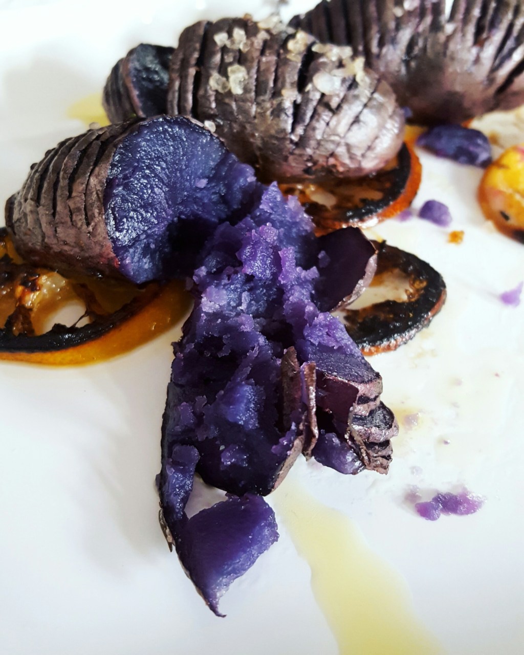 Roasted Purple potatoes on top of lemons with thyme and mediterranean sea&nbsp;salt