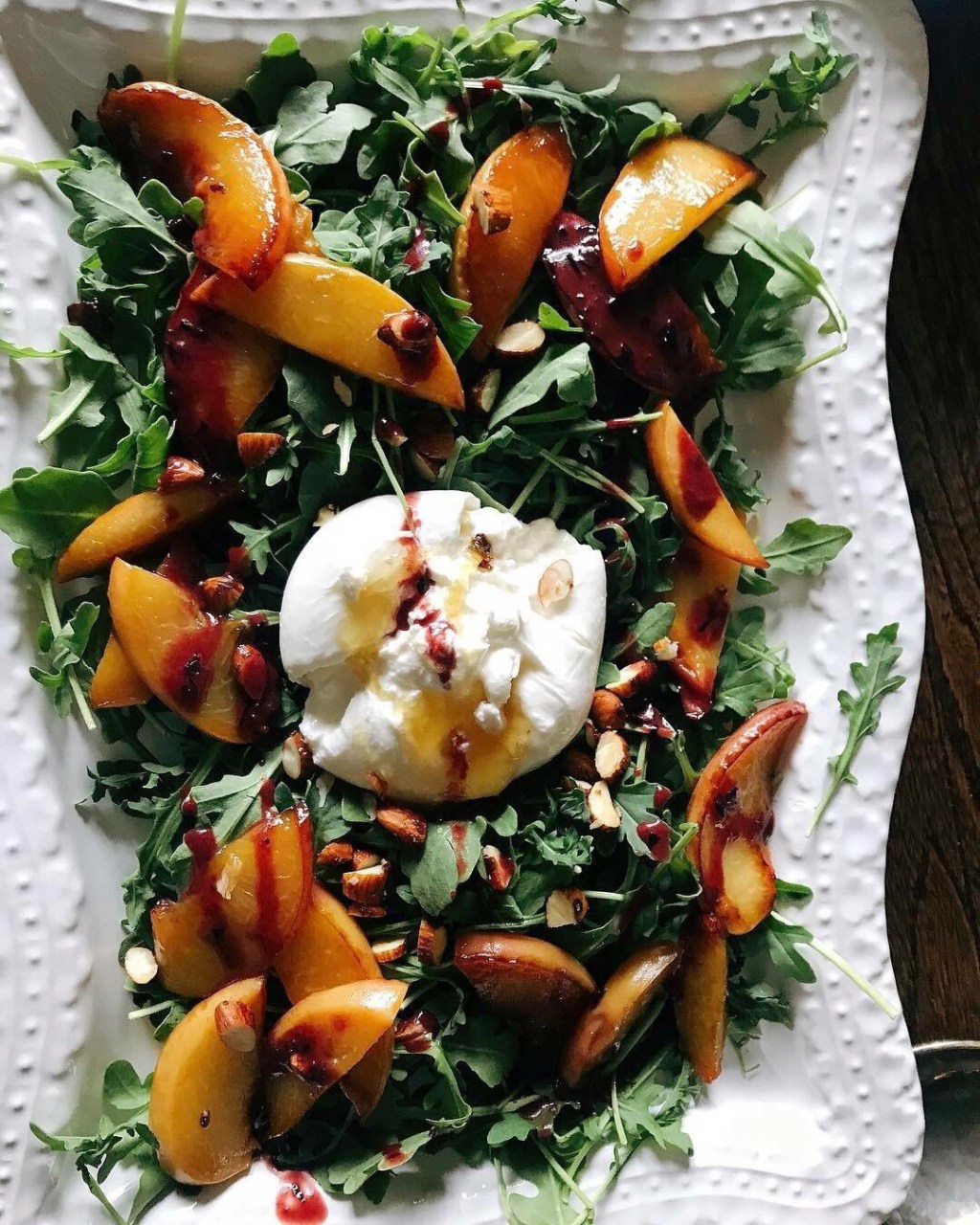 Arugula Salad with Sautéed Peaches, Honey Harissa Almonds, Fresh Burrata topped with Organic Waikiki&nbsp;Honey